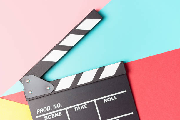 istock The clapperboard on pink, blue and red background close-up, top view. 1307141478