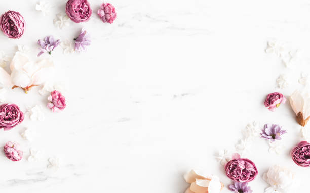 istock Flowers composition. White and purple flowers on marble background. Flat lay, top view 1307142305