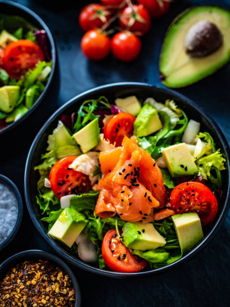 istock Smoked salmon, avocado and vegetables on black table 1307142600