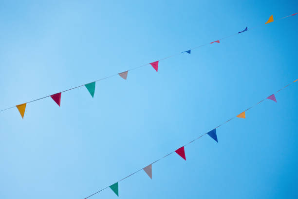 istock Multi-colored Bunting Paper Cut Hanging On The Street 1307145224