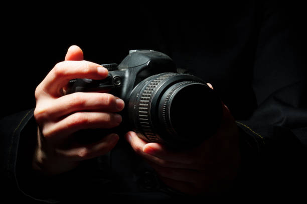 istock close-up of a camera in female hands on a dark 1307145963