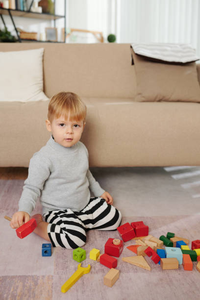 istock Child playing with toys at home 1307146155
