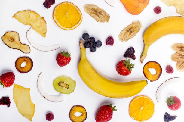 istock assprtied dried  fruits chips scattered on white background. 1307146245