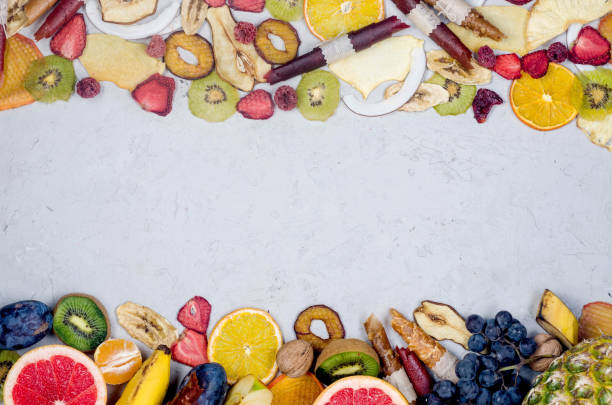 istock assorted ripe fruits and dried chips scattered on grey background. 1307146269