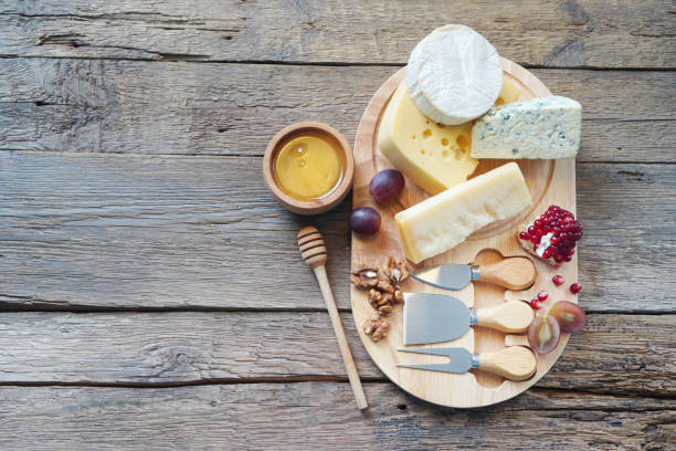 istock Cheese board with camembert cheese, parmesan cheese, maasdam cheese. Top view, copy space. 1307146584