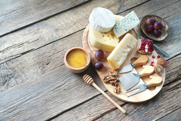 istock Cheese board with camembert cheese, parmesan cheese, maasdam cheese. Top view, copy space. 1307146591