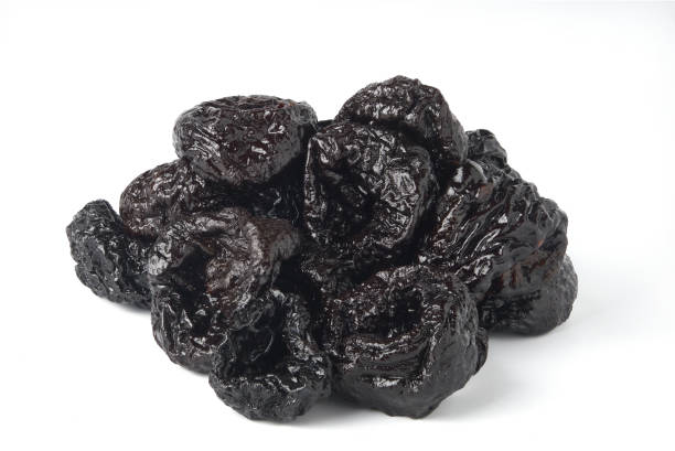 istock Dried prunes isolated on white background 1307147348