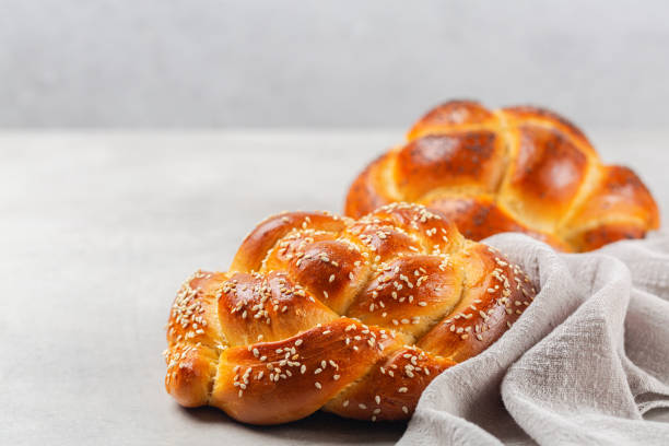 istock Homemade rose braid bread with sesame seeds. Light grey background, copy space. 1307147787