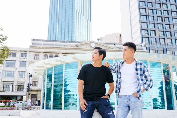 Asian young men in casual clothing standing in the city in summer day