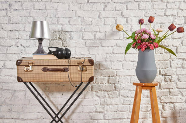 istock vintage style old suitcase behind brick wall 1307148816