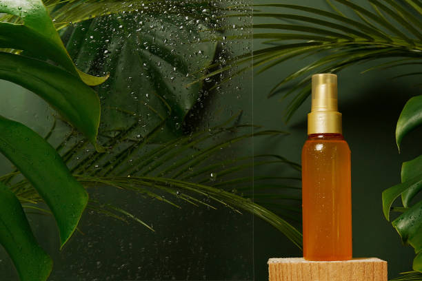 Facial serum fluid cosmetic oil in the bottle with freshness green tropical leaves and water drops on green background. Eco organic natural beauty skincare product. Dermatology and cosmetology Facial serum fluid cosmetic oil in the bottle with freshness green tropical leaves and water drops on green background. Eco organic natural beauty skincare product. Dermatology and cosmetology face serum photos stock pictures, royalty-free photos & images