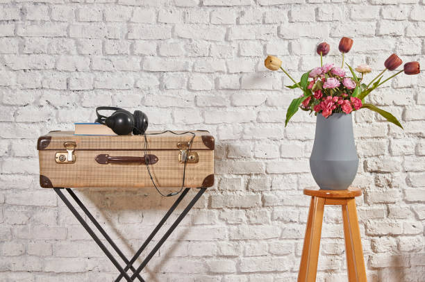 istock vintage style old suitcase behind brick wall 1307148934