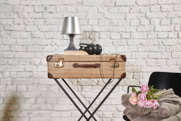 istock vintage style old suitcase behind brick wall 1307149050