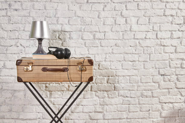 istock vintage style old suitcase behind brick wall 1307149055