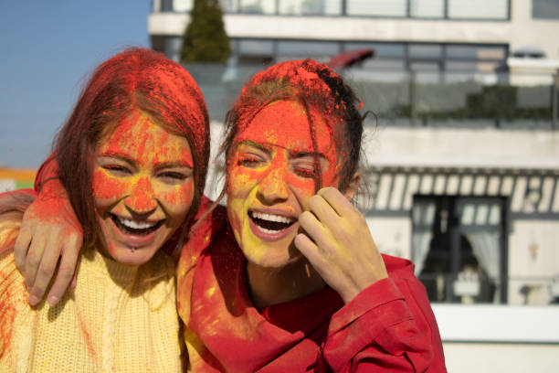 istock happy young people painted with hand and smiling with face 1307149128