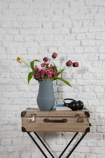 istock vintage style old suitcase behind brick wall 1307149173