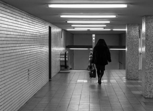 istock Rear View Of Man Walking In Subway 1307149246