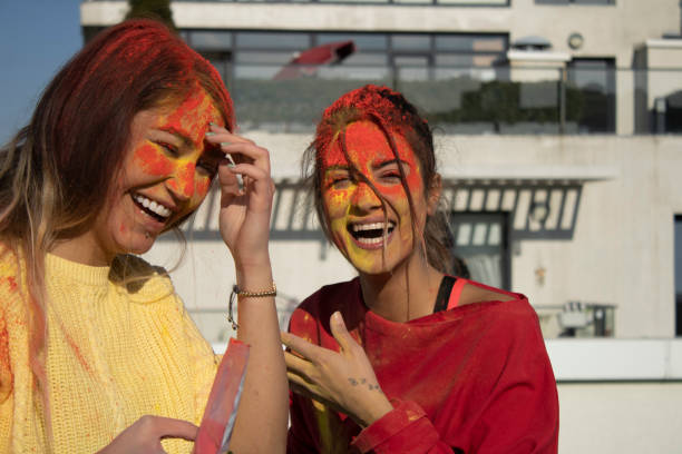 istock happy young people painted with hand and smiling with face 1307149338