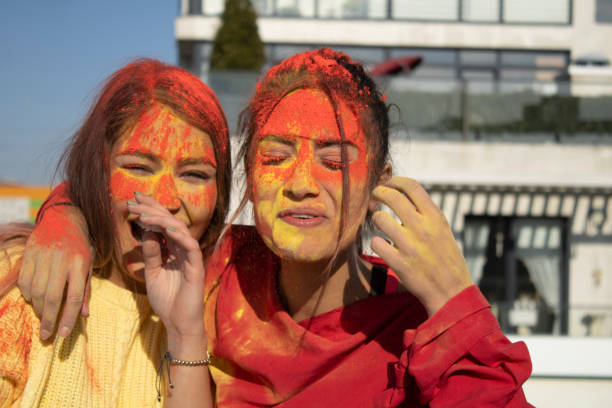 istock happy young people painted with hand and smiling with face 1307149417