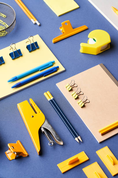 istock Vivid office supplies on blue table 1307151424