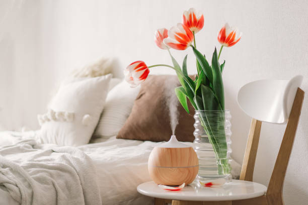 Aroma oil diffuser on chair against in the bedroom.