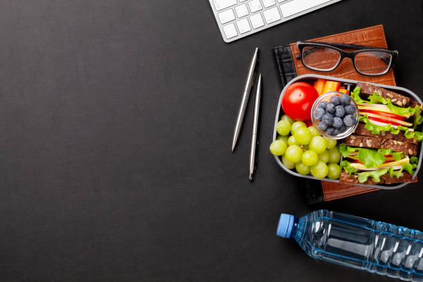 istock Healthy office lunch box with sandwich and fresh vegetables 1307152336