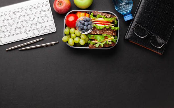 istock Healthy office lunch box with sandwich and fresh vegetables 1307152367