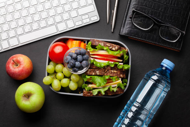 istock Healthy office lunch box with sandwich and fresh vegetables 1307152393
