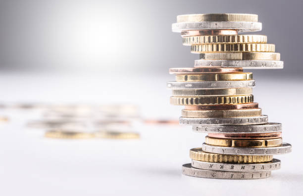 istock Pile of various coins stacked on an imbalanced column 1307152484