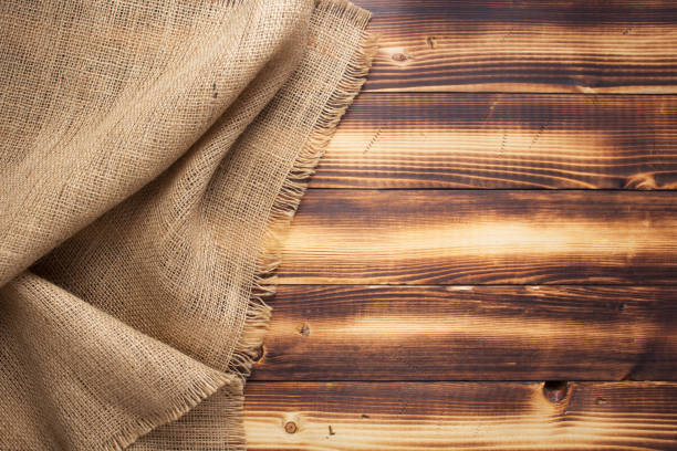 istock burlap hessian sacking texture on wooden background 1307152747