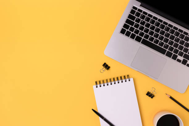 istock Homeschooling workspace with laptop and stationery on a yellow background. 1307155943