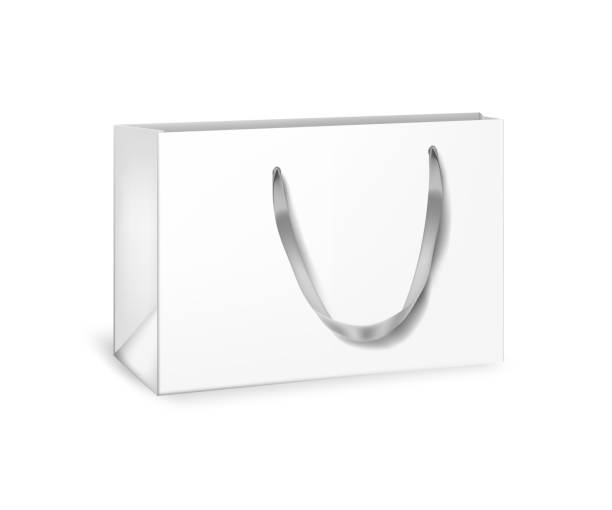 istock White cardboard bag. Blank gift or shopping package with ribbon handle vector illustration. Realistic commercial store carton bag isolated on white background. 1307157329