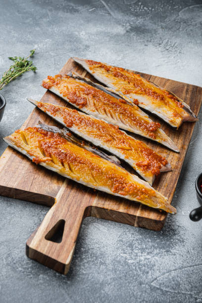 istock Marinated mackerel fillet with garlic and saffron on grey background 1307157435