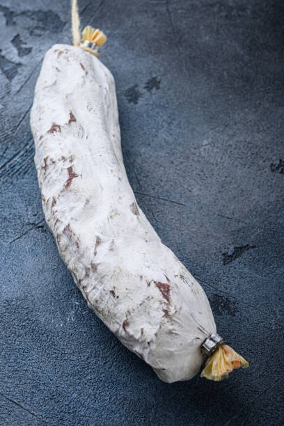 istock Whole spanish salchichon sausage on blue background 1307158445