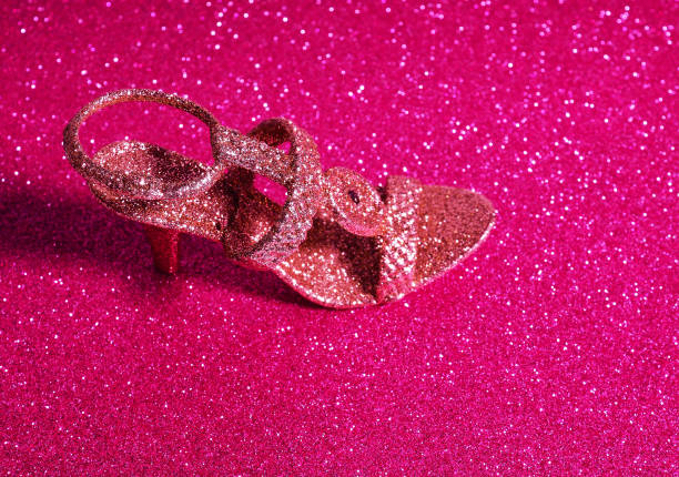 istock golden slipper on a shiny red background 1307158817