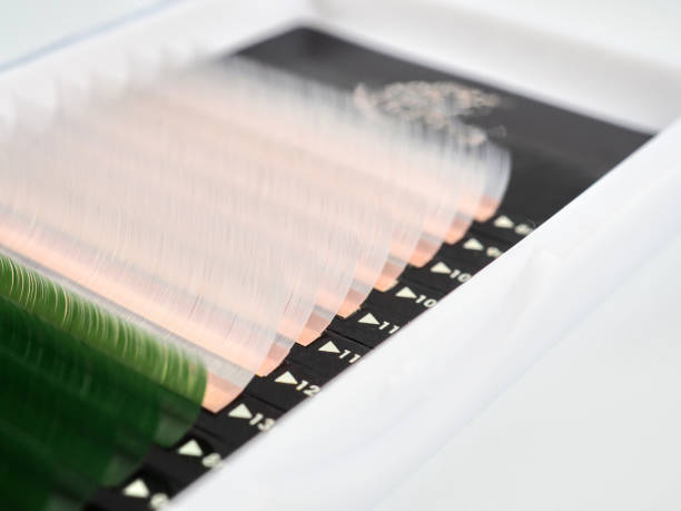 istock Multi-colored artificial eyelashes for extension, two colors in the macro palette, green and white. 1307160546