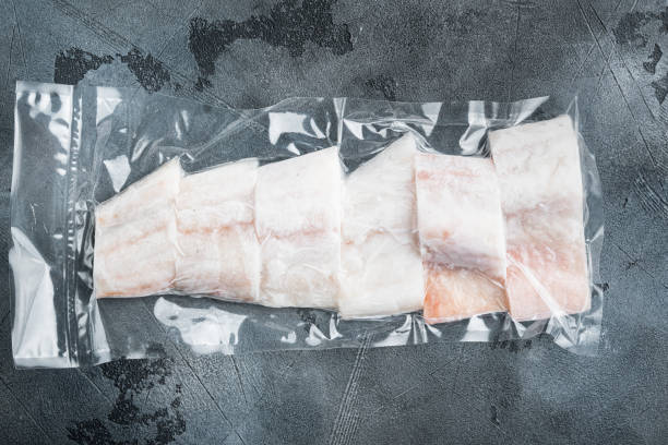 istock Haddock fish skinless in vacuum pack, on gray background, top view 1307160581