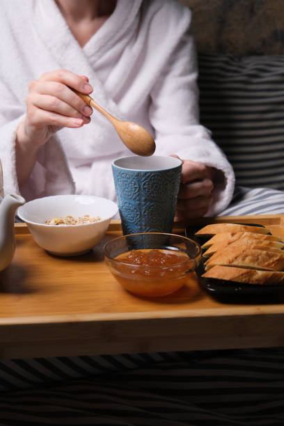 istock Mature woman is having breakfast in bed 1307160699