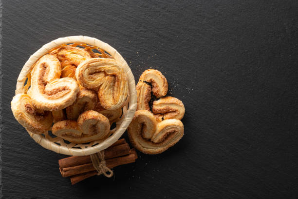 istock crispy puff pastry with sugar and cinnamon on a black stone background, top view, place for text 1307165880