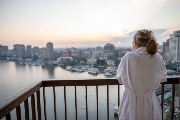 istock Woman in bathrobe contemplates Cairo city 1307169063