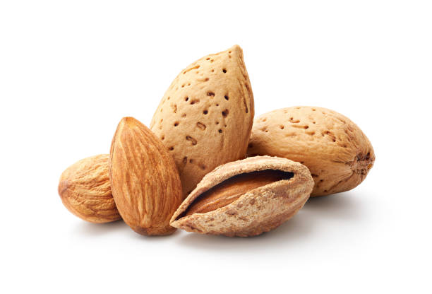 istock Close-up of almonds isolated on white background 1307177974