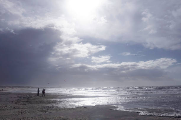 Netherlands. Scheveningen. March 13, 2021. People are looking to the sea with windforce 10 along the coast.