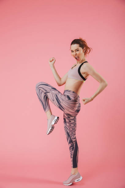 istock Vertical side view image of Cheerful sportswoman doing exercise 1307180939