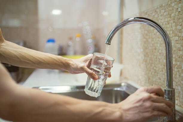 istock Fill a drinking glass with tap water 1307181299