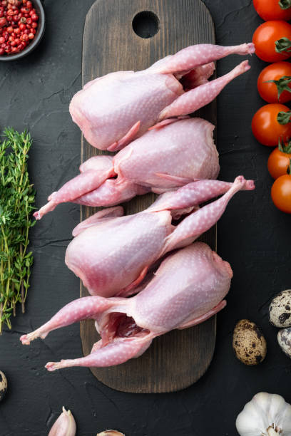istock Homemade eco friendly raw quails, top view, on black textured background 1307181409