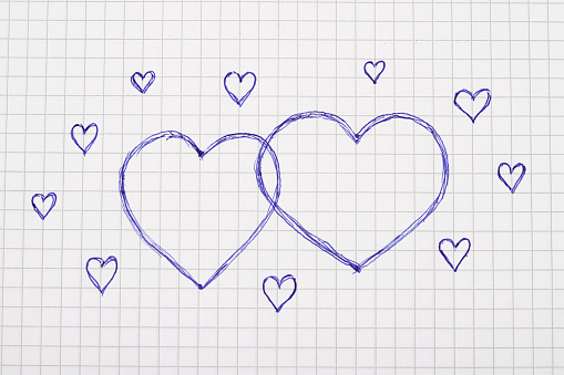 Photography of Two  hearts ,drawn with pen on note pad