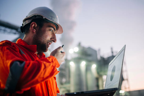 istock Engineer with laptop working in oil refinery 1307181690