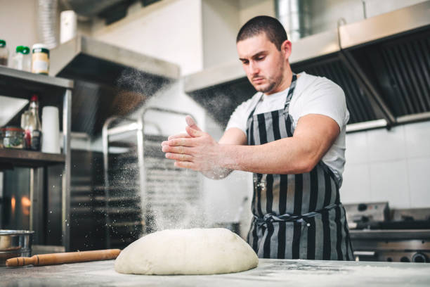 istock Male Chef preparing a pizza in the kitchen 1307182273