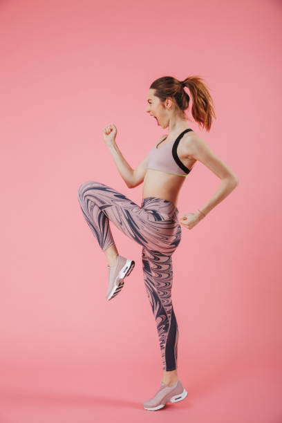 istock Vertical side view image of happy screaming sportswoman doing exercise 1307182493