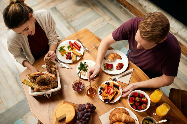 istock Above view of a couple eating breakfast at dining table. 1307182636